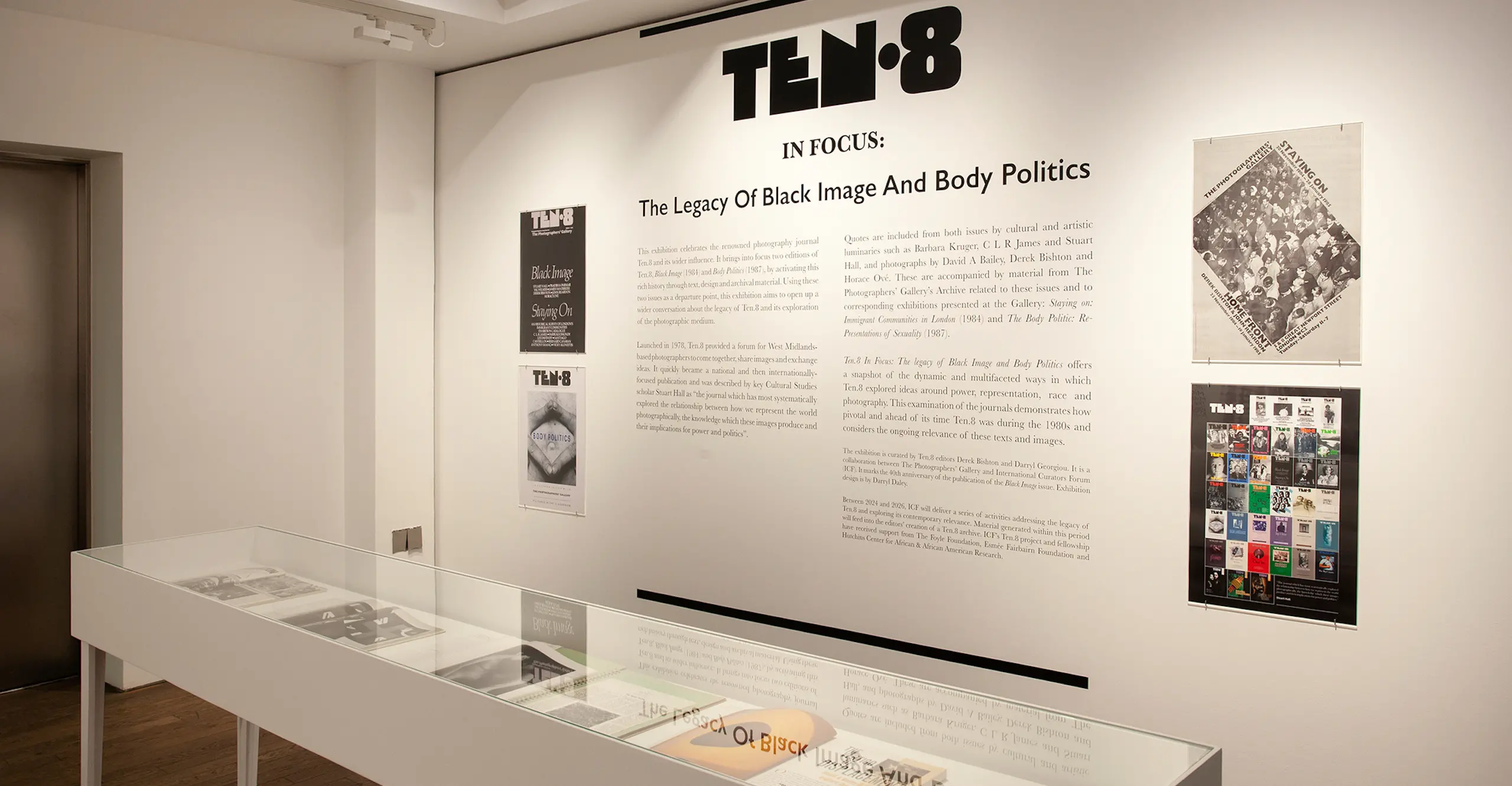 Photograph of an exhibition featuring text and photographs on the walls.